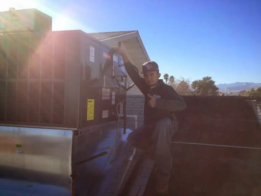 HVAC technician performing AC Tune-Up on a rooftop unit in Edgewater Park